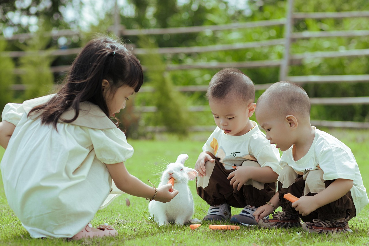 Kids feeding rabbit carrots
